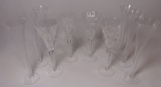 Four Waterford champagne glasses with varying patterns and set of six champagne flutes