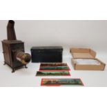 Late 19th century small tinplate magic lantern with a selection of slides H32cm