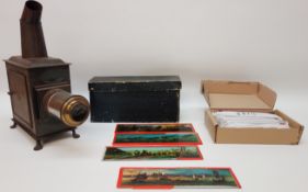Late 19th century small tinplate magic lantern with a selection of slides H32cm