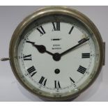 Story of Barrow ship's brass bulk head clock with alloy bezel & white dial with slow/fast lever,