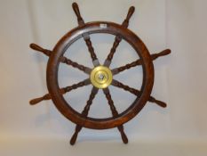 Decorative eight spoked wooden ship's wheel with brass hub,