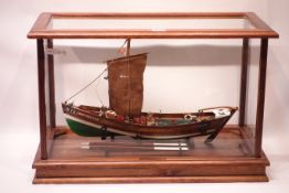 Scale model of Whitby coble Northern Star WY11, with dipping lug sail, in glazed display case,