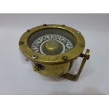 Small brass ship's Pelorus with painted metal dial on swing fitting,