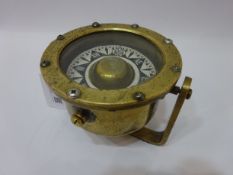 Small brass ship's Pelorus with painted metal dial on swing fitting,