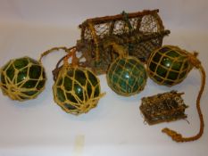 Four green glass fishing floats, a lobster pot and a miniature lobster pot, W30cm,