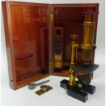 Mid 20th century brass monocular Microscope with three lenses in mahogany case H25cm