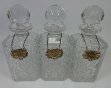 Set of three crystal decanters with hallmarked silver bottle labels, Gin,