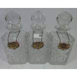 Set of three crystal decanters with hallmarked silver bottle labels, Gin,