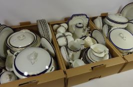 Large quantity of dinner and teaware with blue and gilt borders in three boxes