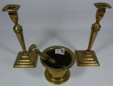 18th Century brass pestle and mortar and a pair of 18th/ early 19th Century candlesticks