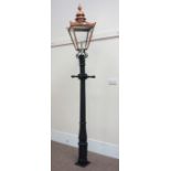 Victorian style cast iron street lamp post with copper and glass lantern top,