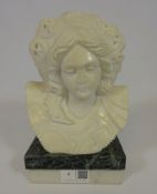 Carved marble bust on marble stand,