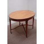 Sheraton style satinwood oval centre table, raised on tapering spade foot legs,