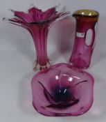 Cranberry glass vase with flared rim,