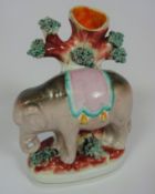 Victorian Staffordshire spill vase in the form of an elephant standing in front of a tree trunk,