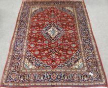 Fine Persian Kashan red ground rug, interlaced floral field, central medallion, repeated in border,