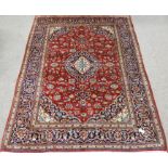 Fine Persian Kashan red ground rug, interlaced floral field, central medallion, repeated in border,