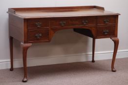 Early 20th century walnut kneehole dressing/writing table, five drawers, W130cm, H81cm,