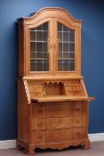 Dutch style oak serpentine bureau bookcase, three drawers and fall front with fitted interior,