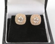 Pair of rose gold diamond cluster ear-rings stamped 750 (centre diamonds approx 1 carat)