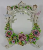 Dresden porcelain wall mirror, frame with two cherubs and flowers.