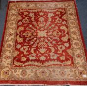 Persian design red and beige ground rug,