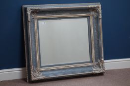 Bevelled glass mirror in swept gilt and painted frame,