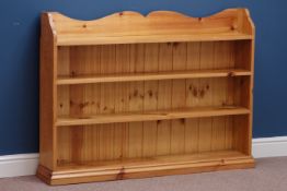 Polished pine open bookcase, W123cm, H92cm,