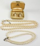 Cultured graduating pearl necklace the clasp set with a seed pearl and stamped silver,