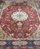 Large Persian design rug carpet, deep red ground, decorated with animals and floral patterns,
