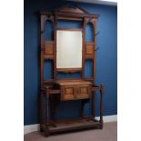 Large Edwardian oak hall stand, bevelled mirror back above panelled double cupboard, W115cm, H220cm,