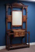 Large Edwardian oak hall stand, bevelled mirror back above panelled double cupboard, W115cm, H220cm,