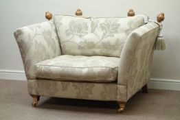 Snuggler sofa upholstered in floral patterned fabric cover,