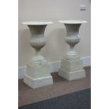 Pair Victorian style white finish cast iron urns on plinths D57cm,