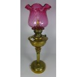 19th/ early 20th Century brass oil lamp with cranberry glass shade converted to electric