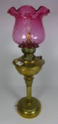 19th/ early 20th Century brass oil lamp with cranberry glass shade converted to electric