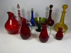 Graduated set of four red glass jugs with clear handles, red overlay decanter,