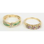 Diamond and emerald gold cross-over ring and an amethyst and diamond scroll gold ring both