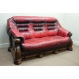 Oak framed three seat sofa upholstered in red leather, three drawers,