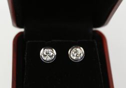 Pair of diamond ear-rings stamped 750 approx 1.