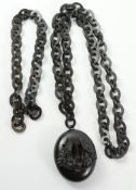 Victorian carved Whitby jet pendant with carved interior scenes of birds in woodland on associated