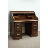 Early 20th century oak twin pedestal, tambour roll top desk, nine drawers and two slides,