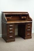 Early 20th century oak twin pedestal, tambour roll top desk, nine drawers and two slides,