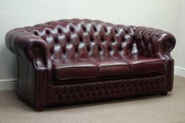 Three seat Chesterfield sofa upholstered in burgundy deeply studded leather,