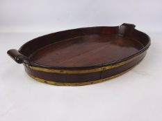 19th century Gillows style brass bound mahogany oval tray with scroll carved handles,