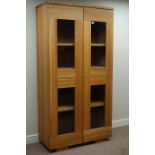 Light oak bookcase enclosed by two glazed doors, W101cm, H196cm,