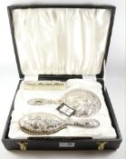 Victorian style four piece silver dressing table set embossed with cherub heads Birmingham 1975
