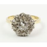 Diamond cluster ring stamped 18ct, centre stone approx 0.