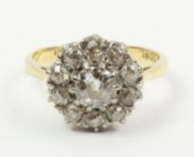Diamond cluster ring stamped 18ct, centre stone approx 0.