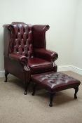 Georgian style wing back armchair upholstered in burgundy leather with footstool